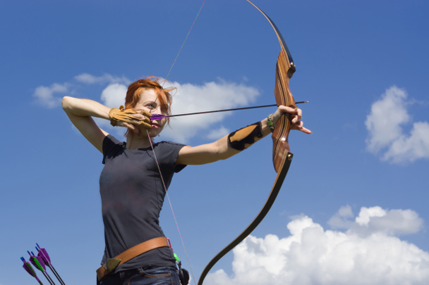 Archery woman bends bow archer target narrow - Foto, Imagen