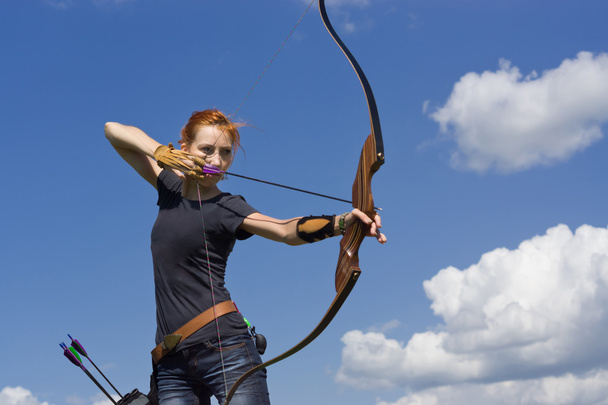 Archery woman bends bow archer target narrow - Photo, Image