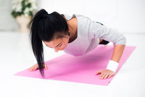 teenage girl doing push ups warming up working at home fitness, sport, training, diet and lifestyle concept - Fotoğraf, Görsel