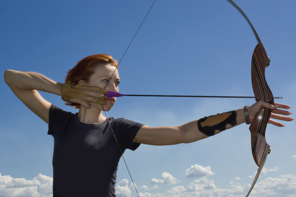 Archery woman bends bow archer target narrow - Photo, Image