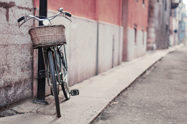 Vintage photo of a bike in the street. Soft focus - 写真・画像
