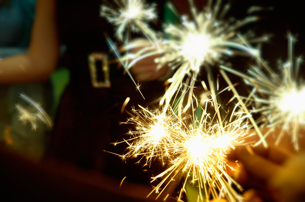 Sparkler in hands on a party - Foto, afbeelding