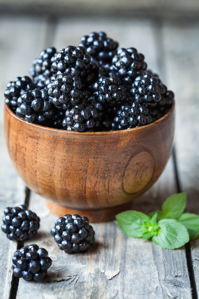 Healthy vegetarian blackberry sweet organic snack in wooden bowl, vintage table background. - Photo, Image