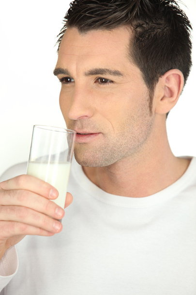 Man drinking milk on white background - Φωτογραφία, εικόνα