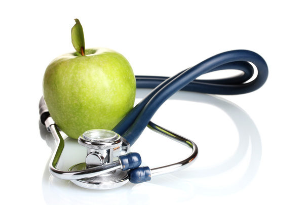 Medical stethoscope and green apple isolated on white - Фото, зображення