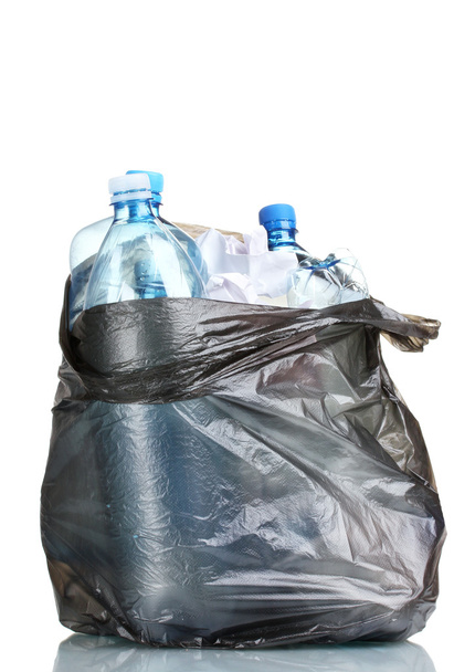 Open black garbage bag with trash isolated on white - 写真・画像