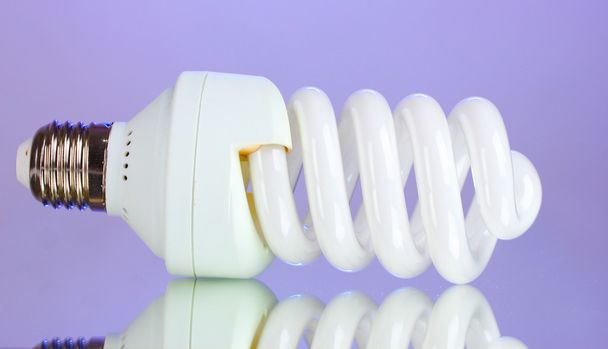 Energy saving light bulb on purple background - Foto, immagini