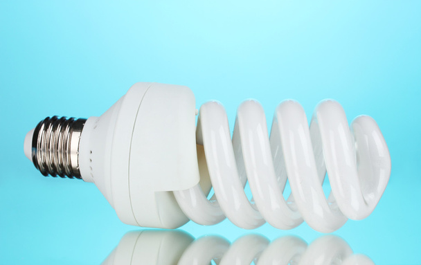 Energy saving light bulb on blue background - Photo, Image