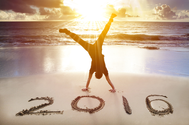 happy new year 2016. young man handstand on the beach - Photo, Image