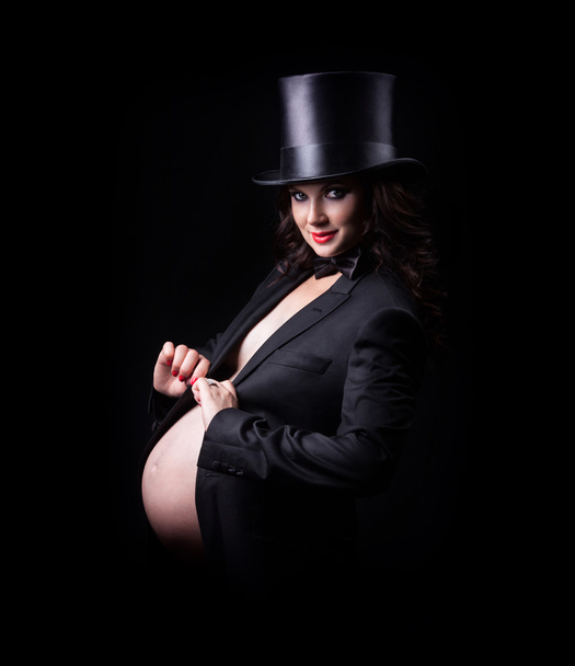 Pregnant woman in evening dress and hat cylinder - Foto, Imagem