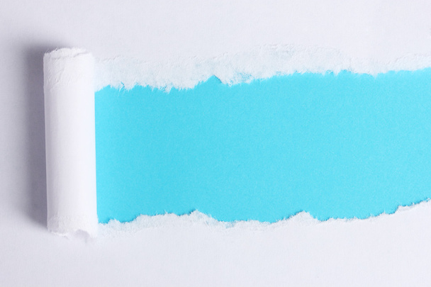 Torn paper with blue background - Фото, зображення