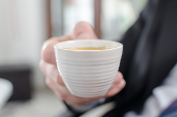 Businessman holding a cup of coffee - Photo, Image