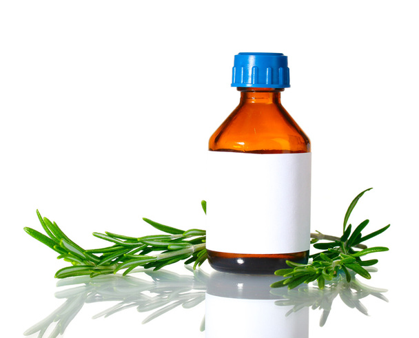 Medical bottle and fresh green rosemary isolated on white - Foto, Imagem