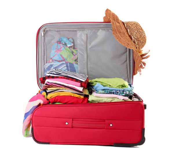 Open red suitcase with clothing isolated on a white - Foto, Imagem