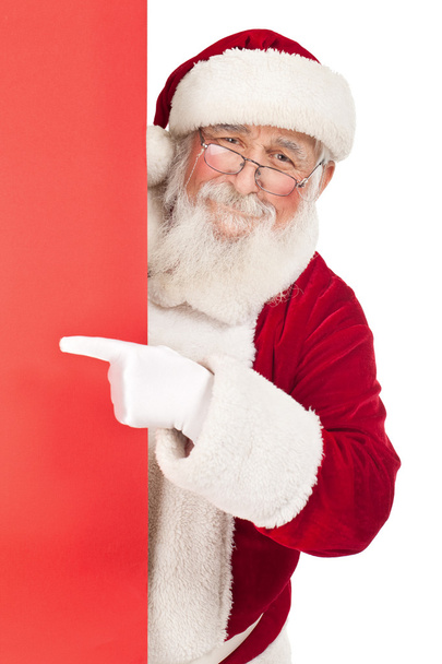Santa pointing in red sing - 写真・画像