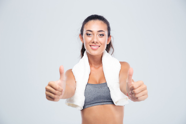 Fitness woman with towel showing thumbs up - Photo, image