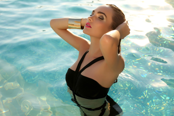 sensual woman with dark hair wearing elegant bikini - Фото, изображение