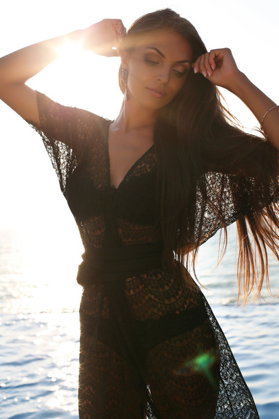sensual woman with dark hair in black bikini and lace robe  - Photo, Image