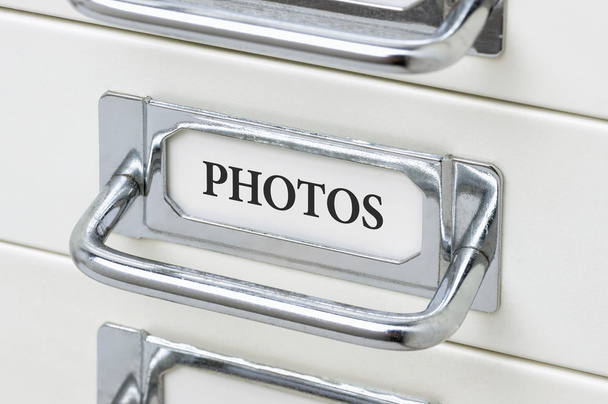 A drawer cabinet with the label Photos - Photo, Image
