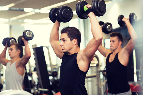 group of men with dumbbells in gym - Foto, Imagem