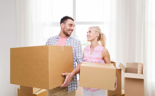 couple with big cardboard boxes moving to new home - Valokuva, kuva
