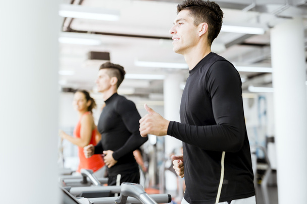 Group of people using treadmills in a gym - Foto, Imagem