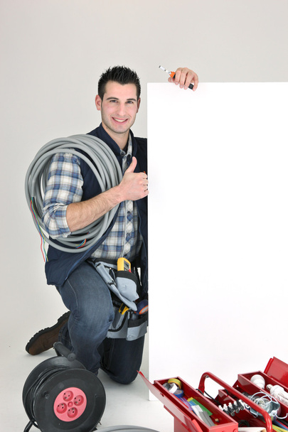 Craftsman holding an ad board - Zdjęcie, obraz