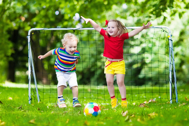 Kids playing football in school yard - Foto, afbeelding