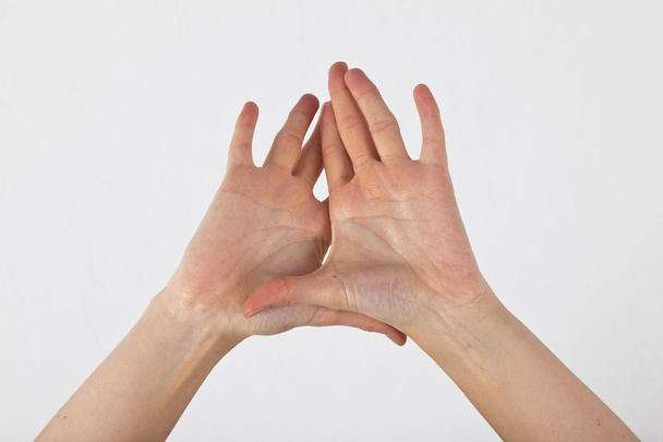 A womans hand is shown in yoga gesture - Fotografie, Obrázek