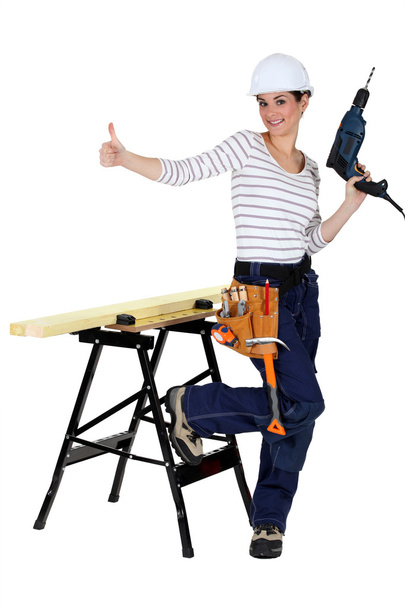Happy-looking female carpenter thumb up - Фото, изображение