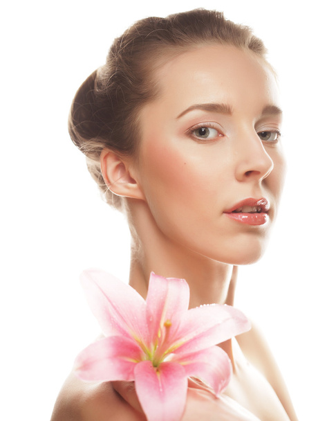 Beauty face of the young woman with pink lily  - Foto, imagen