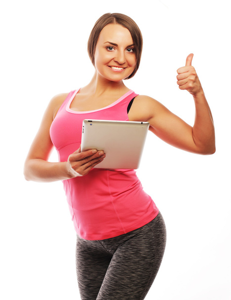 Young sporty woman using a digital tablet  - Zdjęcie, obraz