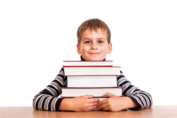 Schoolboy and a heap of books - Φωτογραφία, εικόνα