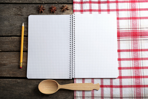 Open recipe book and spices on napkin, on wooden background - Zdjęcie, obraz