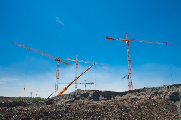 Cranes above the soil pile - Photo, Image