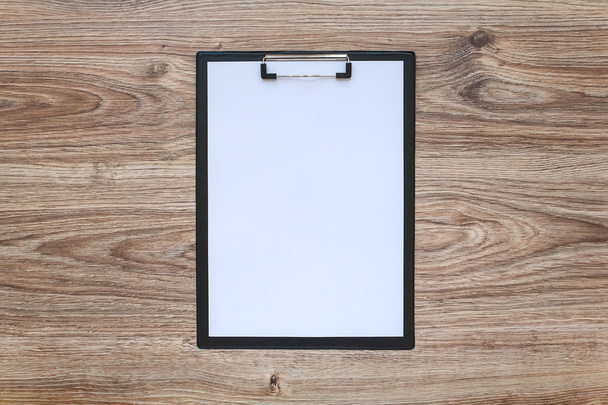 blank paper in clipboard on wooden table - Photo, Image
