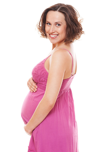 Gelukkig zwangere vrouw in roze sundress - Foto, afbeelding