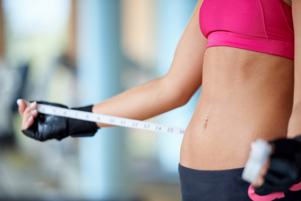 young fit woman measuring belly - Photo, image
