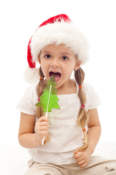 Christmas girl with fir tree shaped candy - Foto, Bild