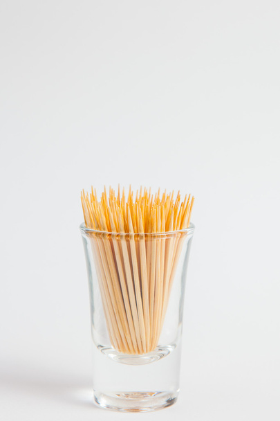 Toothpick in the glass on white paper background - Zdjęcie, obraz