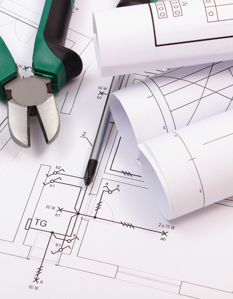 Work tools and rolls of diagrams on construction drawing of house - Photo, Image