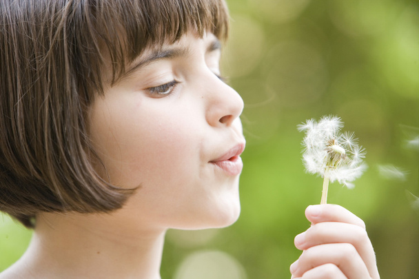 Girl blowing a dandelion - Photo, Image