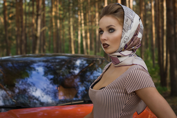 Lady in vintage dress standing near car - Photo, Image
