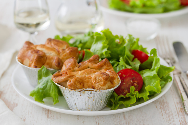 Pie with chicken with salad on white plate - Foto, imagen