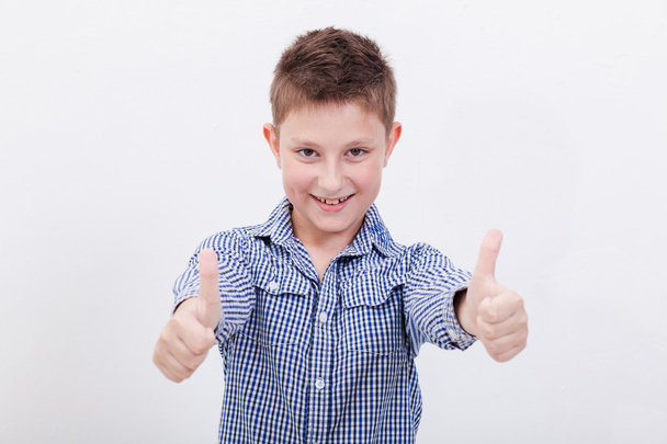 Portrait of happy boy showing thumbs up gesture - Zdjęcie, obraz
