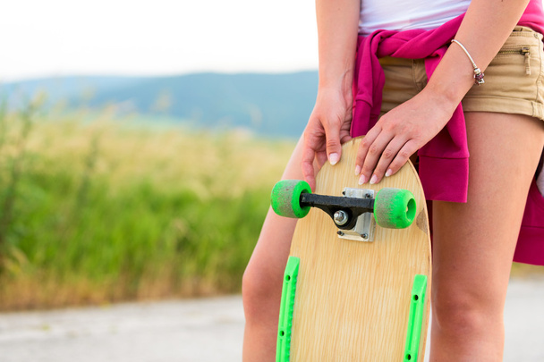 Anonymous teenage girl with skateboard - Фото, изображение