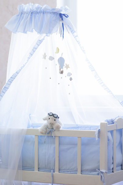 Baby cot with hanging wooden toys. - Photo, Image