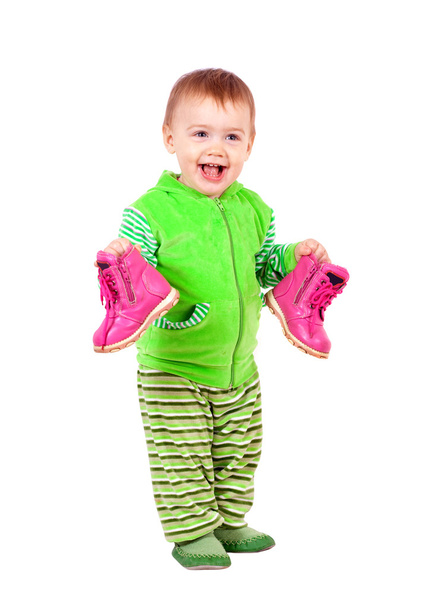 Happy toddler holds shoes - 写真・画像