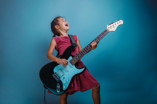 Teenage girl playing electric guitar studio background photo sta - Photo, Image