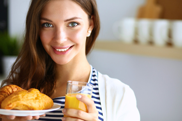 Young woman with glass of juice and cakes - Foto, imagen